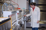 Photo of chemist using soxtherm equipment to peform soil extraction for organic chemical compounds.