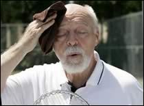 A man wiping sweat from his face.