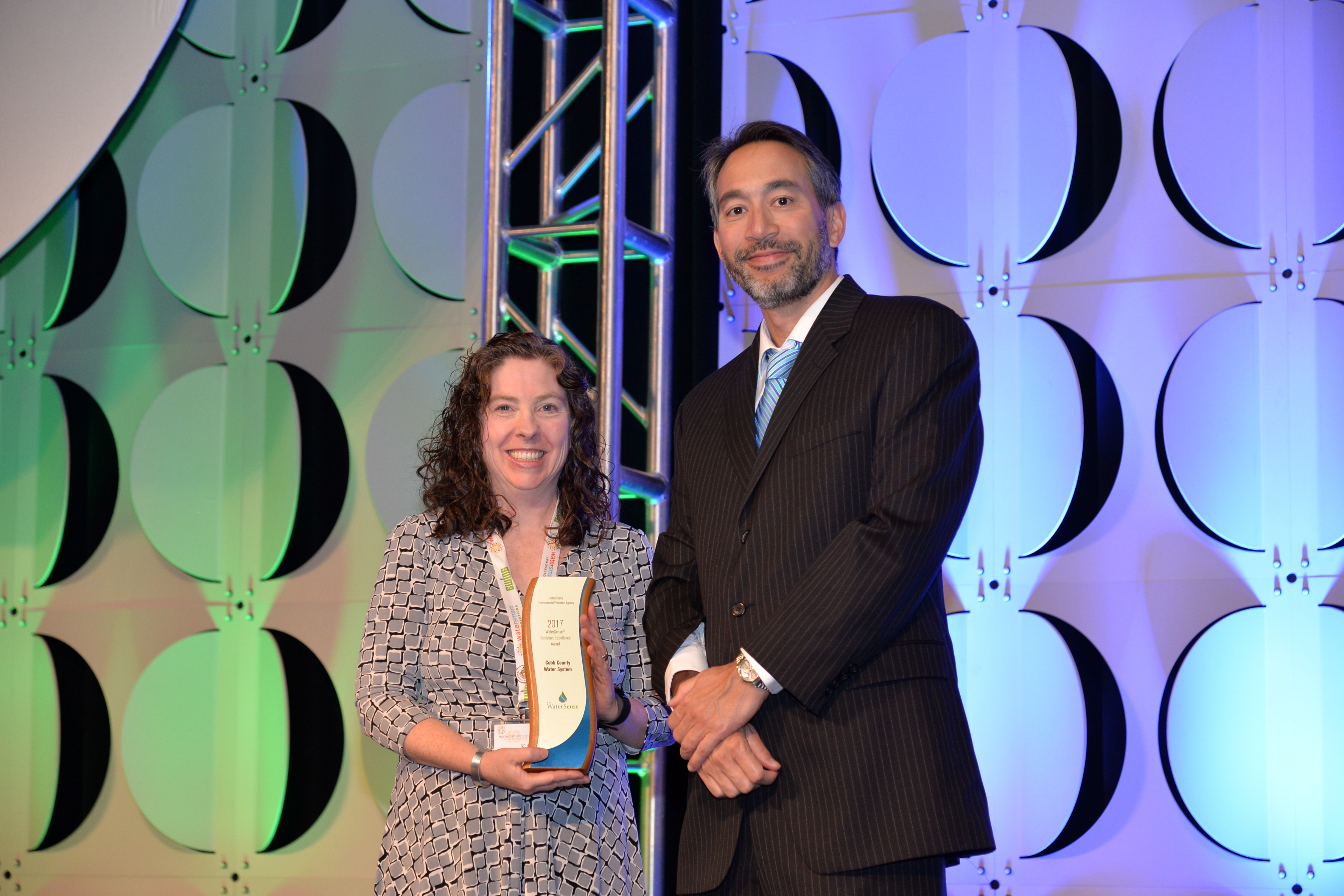 Kathy Nguyen accepts Sustained Excellence Award for Cobb County Water System.