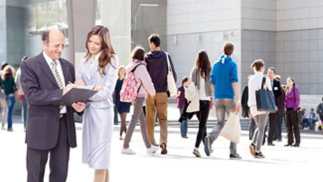 Outdoor plaza with office workers walking