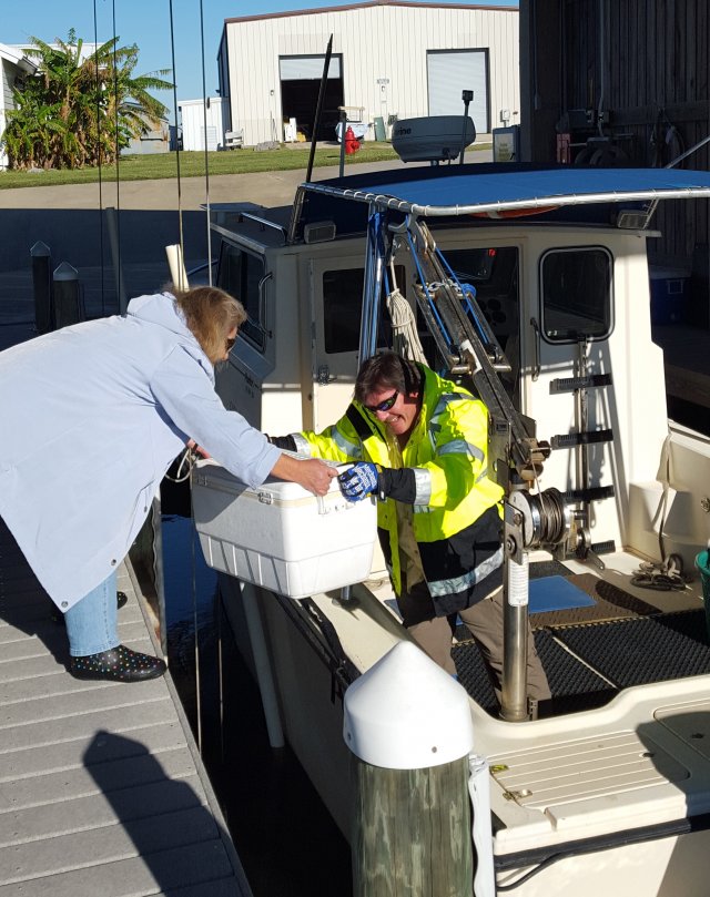 Linda helps carry equipment off boat