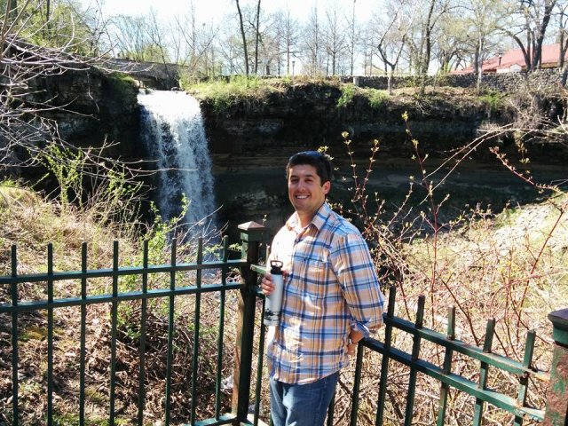 Jason Berner stands in front of a waterfall