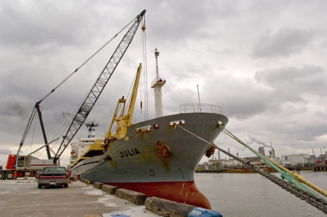 Ship in port being loaded with cargo