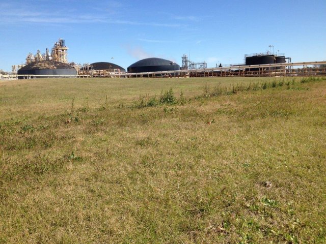 A capped area of the site, with continued industrial reuse in the background