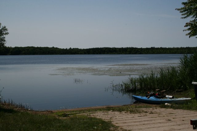 A picture of a kayak next to a lake