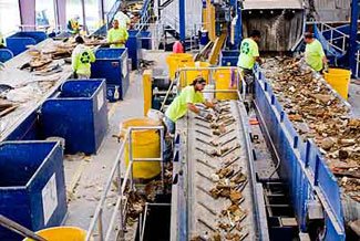 Workers with conveyor belts full of construction debris for sorting