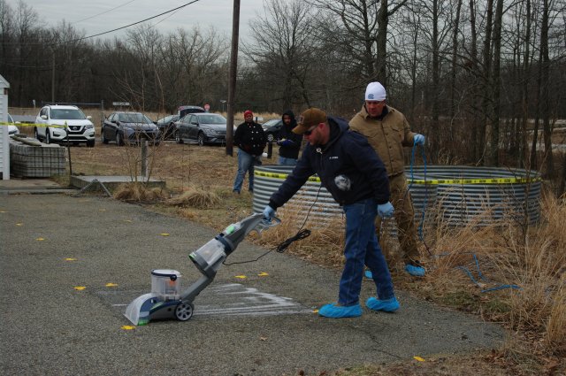 EPA researchers use wet vacuum samplers to assess results of outdoor sample collection methods over time and for different surfaces.