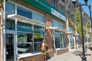 Woman walking down the side walk in front of the Bethel Community Savings Center