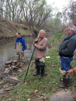 Photo of the Regional Monitoring Network team working on the bank of a stream.