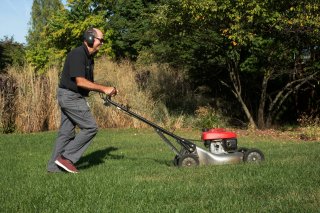 Person mowing landscape.