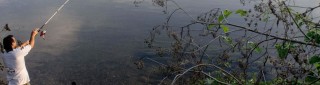 A person fishing in a lake.