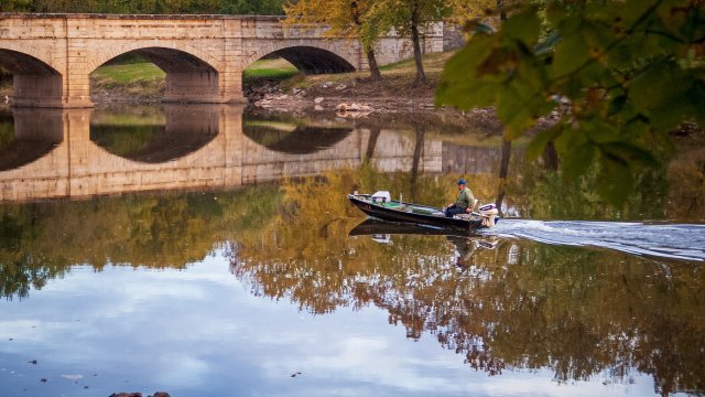 Boat and waterway with bridge in background