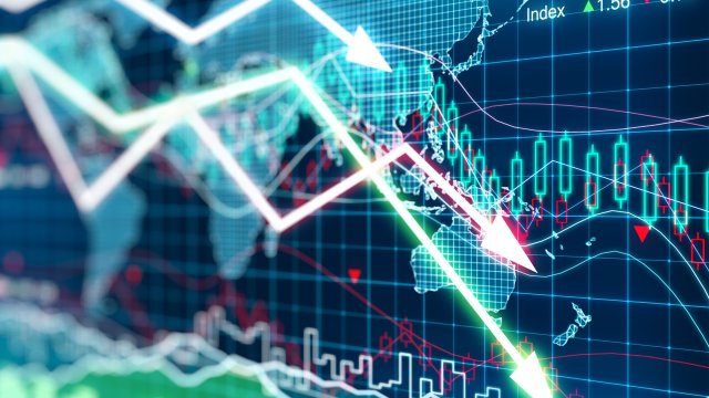 a series of arrows descending from top left ot bottom right of the image over a series of stock-related graphs and a world map