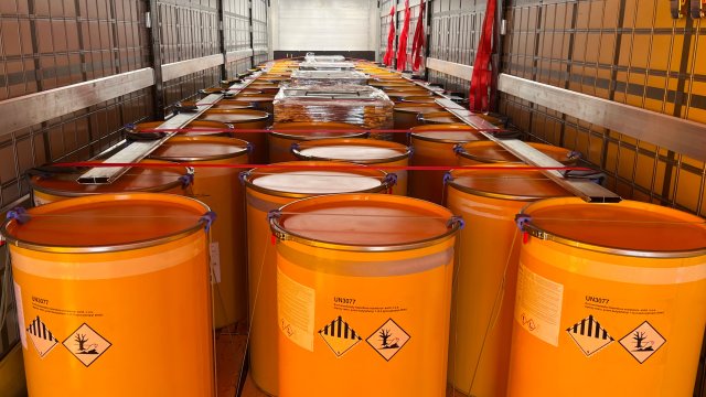 truck full of orange drums