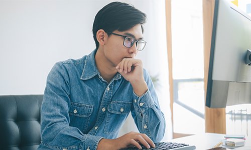 Man sitting starting at a computer