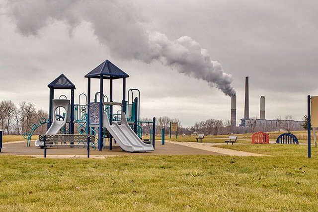 Playground with smokestacks in background