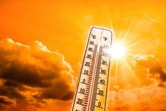 depiction of extreme heat with bright sun and with soaring temperature on a thermometer