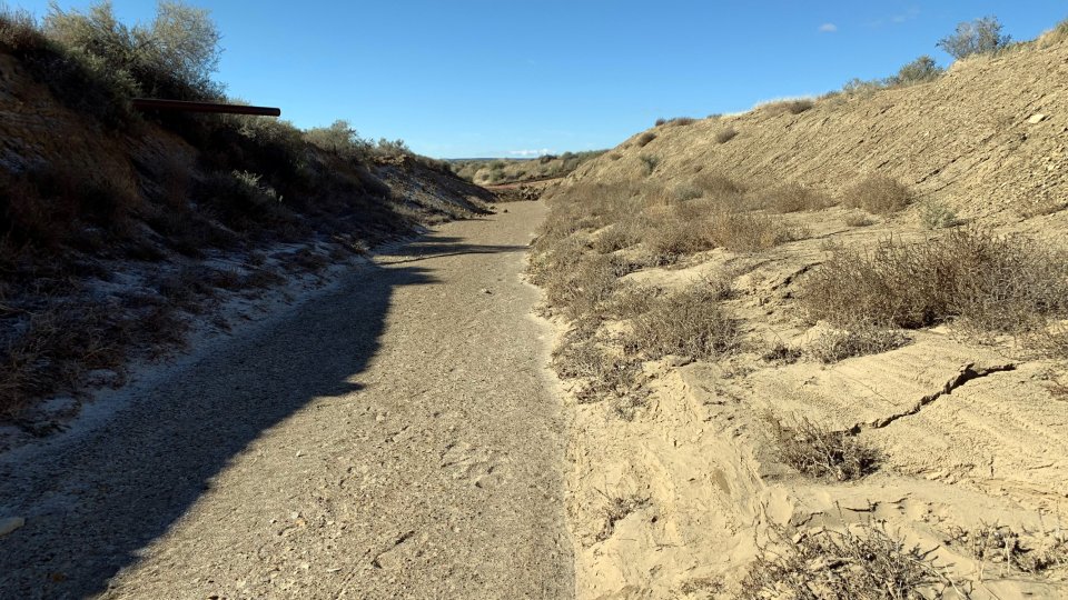 Dry creek bed in desert landscape