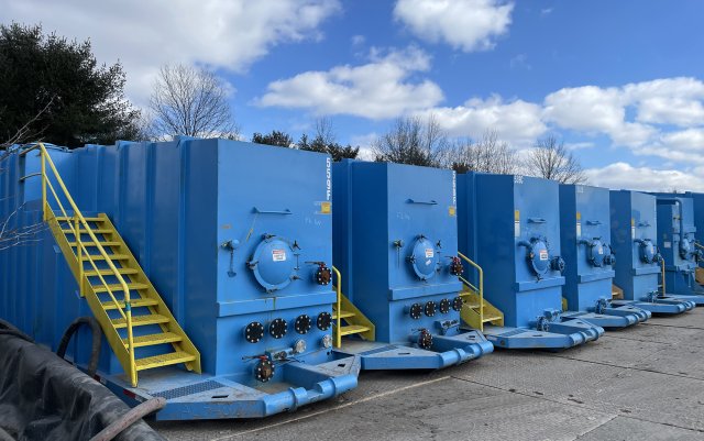 Large blue tanks of wastewater