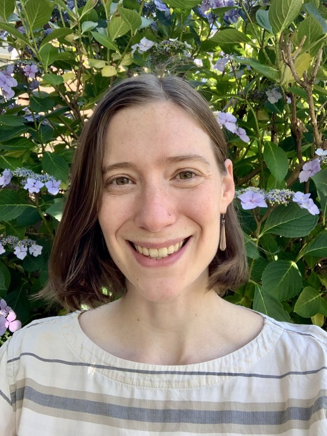 amalia handler smiling in front of flower tree