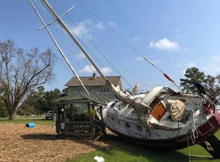 Boat lying in a yard after Hurricane Matthew