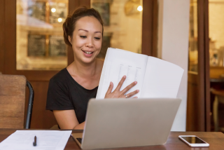 Woman teaching a class online from her home.