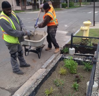 Two men helping construct a bioswale at Long Island Sound Study