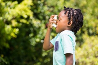 Child using a rescue inhaler.