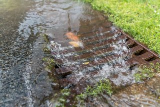 municipal storm drain with stormwater rushing in