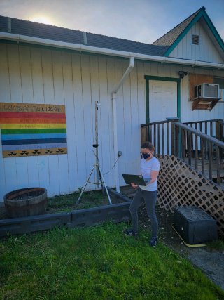 Amara Holder taking measurements in a community.