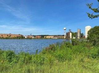 Wetlands and aquatic area in front of an industrial facility