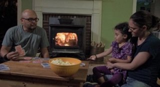 family playing a board game seated near fireplace