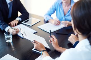 Four people sitting around a table discussing