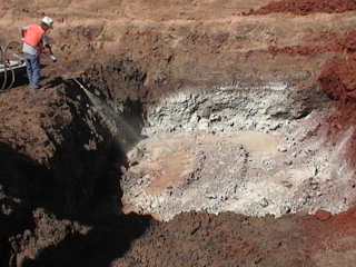 man spraying oxygen releasing compound slurry onto contaminated soil.