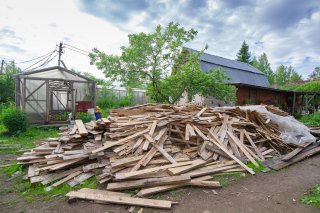 Pile of planks after renovation of building. Heap of broken boards with nails. Old boards. Repair of the building. Construction garbage