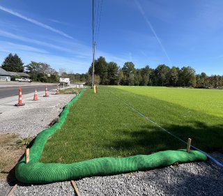 One of the fully restored tank farm areas with fresh sod visible from Taggart Road.