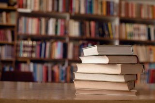 pile of books in a library