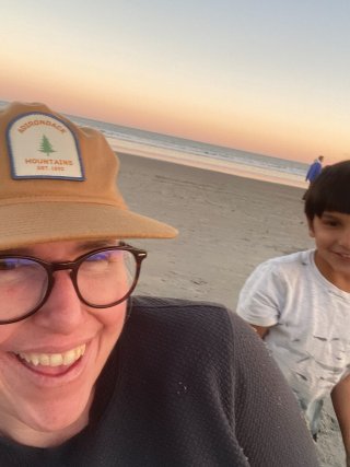 EPA researcher Kste Mulvaney smiling in a selfie with her son on a beach