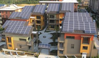 Photo of houses with solar panels on their roofs