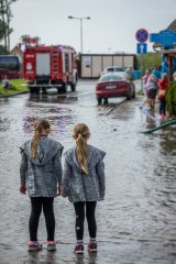 2 children standing in flooded area